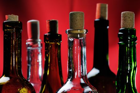 Wine bottles on the red background. Narrow depth of field.の写真素材