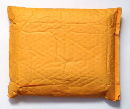 Sealed packet made from yellow paper.の写真素材