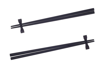 Black chopsticks isolated on the white background.の写真素材