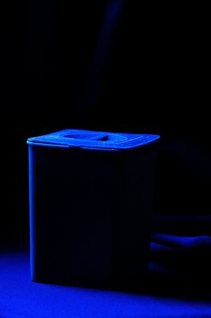 Blue plastic container on the blue fabric.