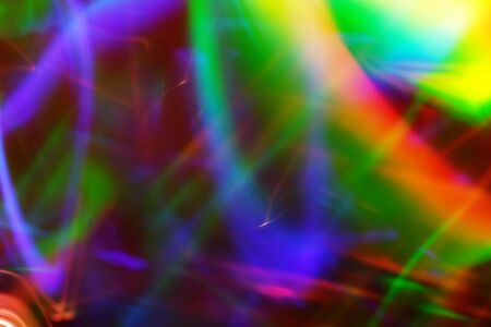 Spectrum colored reflection on the pile of dvd disks.の写真素材