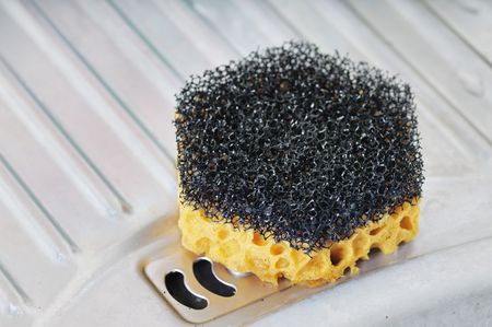 Hexagonal sponge on the metal sink. Narrow depth of field.の写真素材