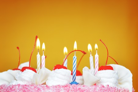 Candles on the birthday cake. Narrow depth of field. Close-up. Orange tint.の写真素材