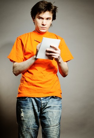 Man with notebook and pencil in the hands.の写真素材