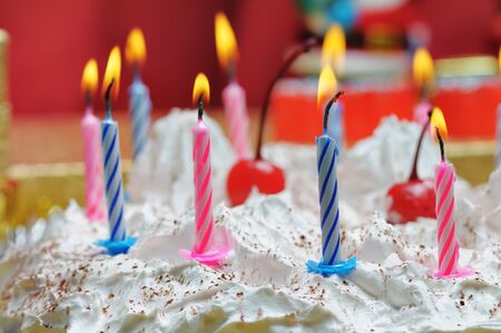 Candles on the birthday cake. Narrow depth of field. Close-up.