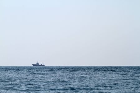 Seascape with small ship on the horizon.の写真素材