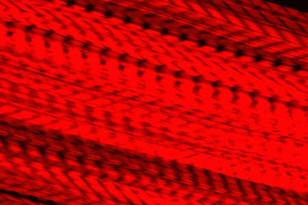 Motion blurred lighting abstract. Red colored lines over black background.の写真素材