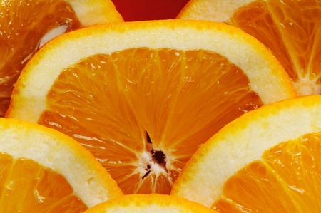 Citrus slices on the red ceramic plate. Close-up.の写真素材