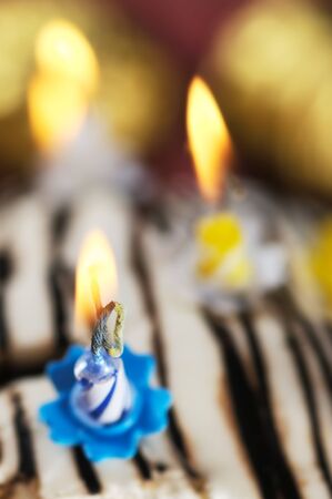 Candles on the birthday cake. Narrow depth of field. Close-up.の写真素材