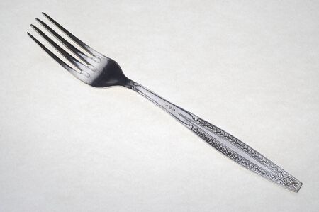 Fork on the white background. Old and used.の写真素材