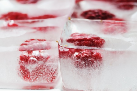 Fresh raspberry frozen in the ice cubes 