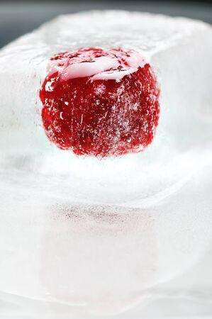 Fresh raspberry frozen in the ice cube の写真素材