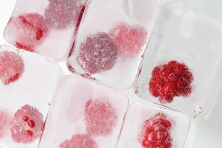 Raspberry frozen in the ice cubes  White background の写真素材