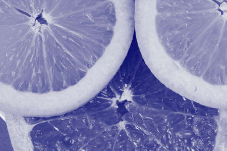 Close-up of citrus slices on the plate  Blue tint の写真素材