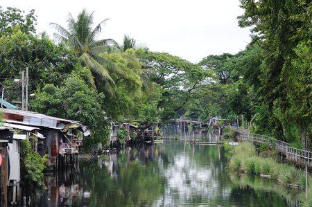 BANGKOK - SEPTEMBER 8: Small houses on the river on the outskirts of Bangkok. Bangkok, Thailand - September 8, 2011.のeditorial素材