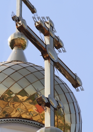 Gold cross on gold dome of church の写真素材