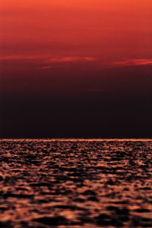 Sea water underneath night sky の写真素材