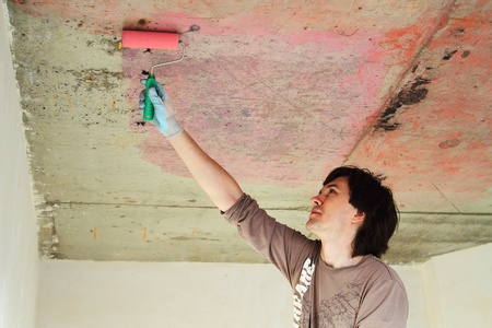 Plasterer conducts preparatory work on concrete ceiling の写真素材