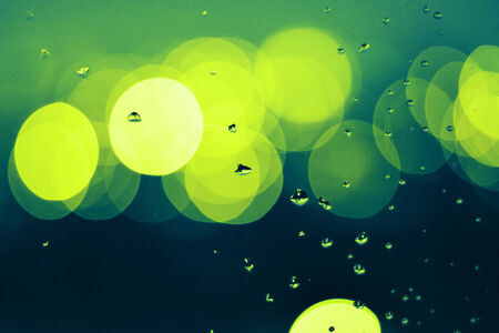Raindrops on the window glass. In front of out of focus background.