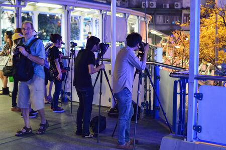 BANGKOK - DECEMBER 10: Group of photographers in downtown of Bangkok. Bangkok, Thailand - December 10, 2012.のeditorial素材