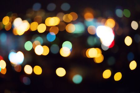 Beautiful bokeh circles on defocused night street photo.