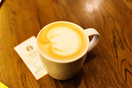 BANGKOK, THAILAND - AUGUST 15, 2016: Coffee mug on the table in Starbucs coffee shop in downtown of Bangkok.のeditorial素材