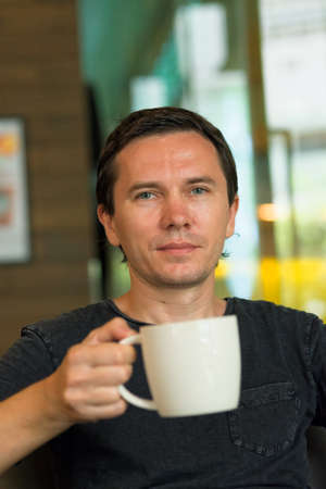 Caucasian tourist relaxes in exotic Asian restaurant.の写真素材