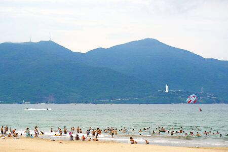 DA NANG, VIETNAM - JULY 29, 2017: Calm and peaceful beach of Da Nang city. Tourists and locals are walking and resting in the relaxed atmosphere of this city. Da Nang is a Vietnamese resort famous for its beaches.のeditorial素材