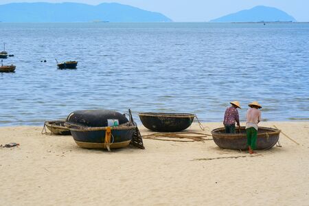 DA NANG, VIETNAM - AUGUST 1, 2017: Coracle fishing boats on the beautiful public beach located in Da Nang city.のeditorial素材