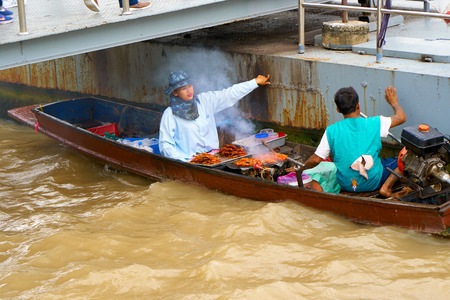 BANGKOK, THAILAND - July 14, 2017: Food vendors on the boat on the famous Chao Phraya River in Bangkok, Thailand.のeditorial素材