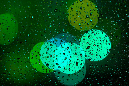 Abstract out of focus background. View through the window glass in rainy weather.