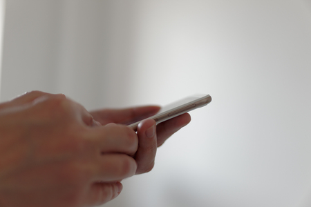 Man looking to smartphone in his hands.の写真素材