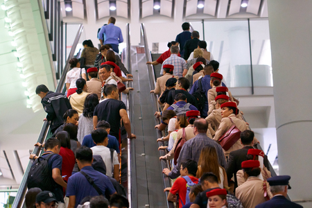 HONG KONG - September 1, 2017: Passengers and cabin crew riding up an escalator at Hong Kong...