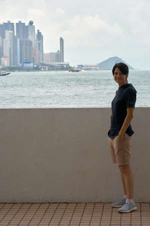 HONG KONG - September 5, 2017: Female european tourist is posing on the street of big city in time of happy vacation trip.のeditorial素材