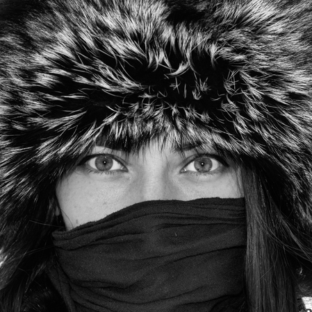 mysterious look girl in a fur hatの写真素材