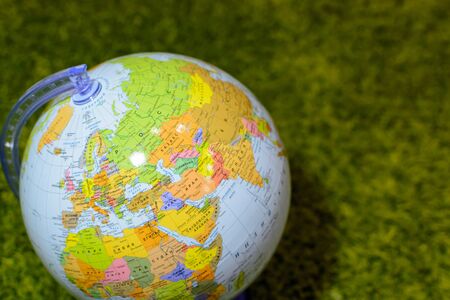 globe on background of green grass, concept of ecologyの写真素材