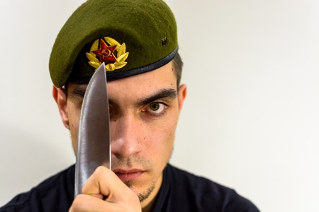 young soldier in a green beret intelligence