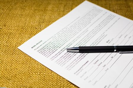 Several model release forms are on the deskの写真素材