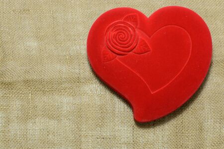 A red heart isolated on fabric backgroundの写真素材