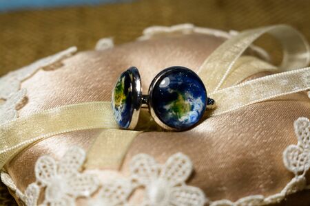 silver cufflinks with a picture of the earthの写真素材