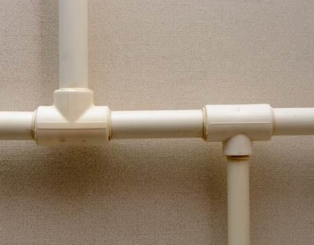 Old plastic Central heating pipes in apartmentの写真素材