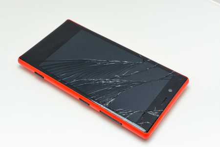 Smartphone with broken screen on white backgroundの写真素材