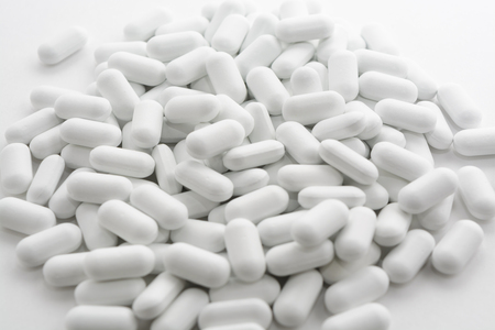 pile of pills on a white background.