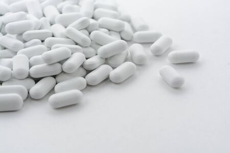 pile of pills on a white background.