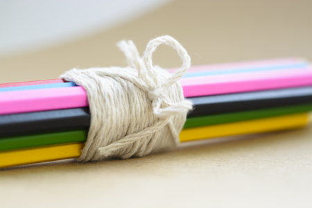 colored pencils closeup. lie in the group are connected by a ropeの写真素材
