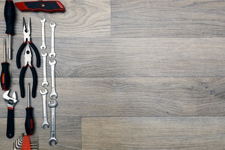 Tools for repairing top view on wood background, space for text