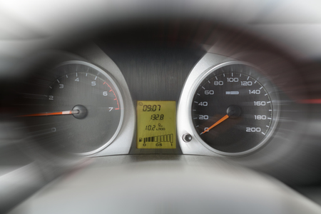 The dashboard and steering wheel of the car in the blur, fast, speed