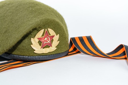 Military cap on a white table and place for inscription and St. George's ribbonの写真素材