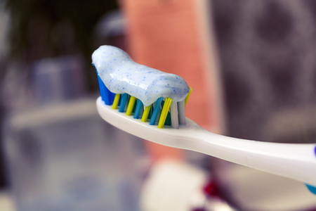 Toothbrush and toothpaste on blurred background lies empty tube of toothpasteの写真素材