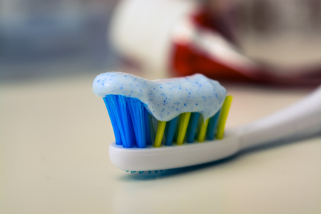 Toothbrush and toothpaste on blurred background lies empty tube of toothpasteの写真素材